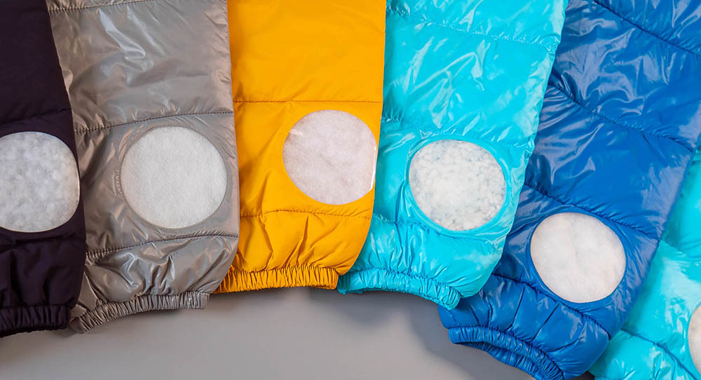 Colorful jackets displaying comfortemp® insulation application through circular cutouts in each sleeve.